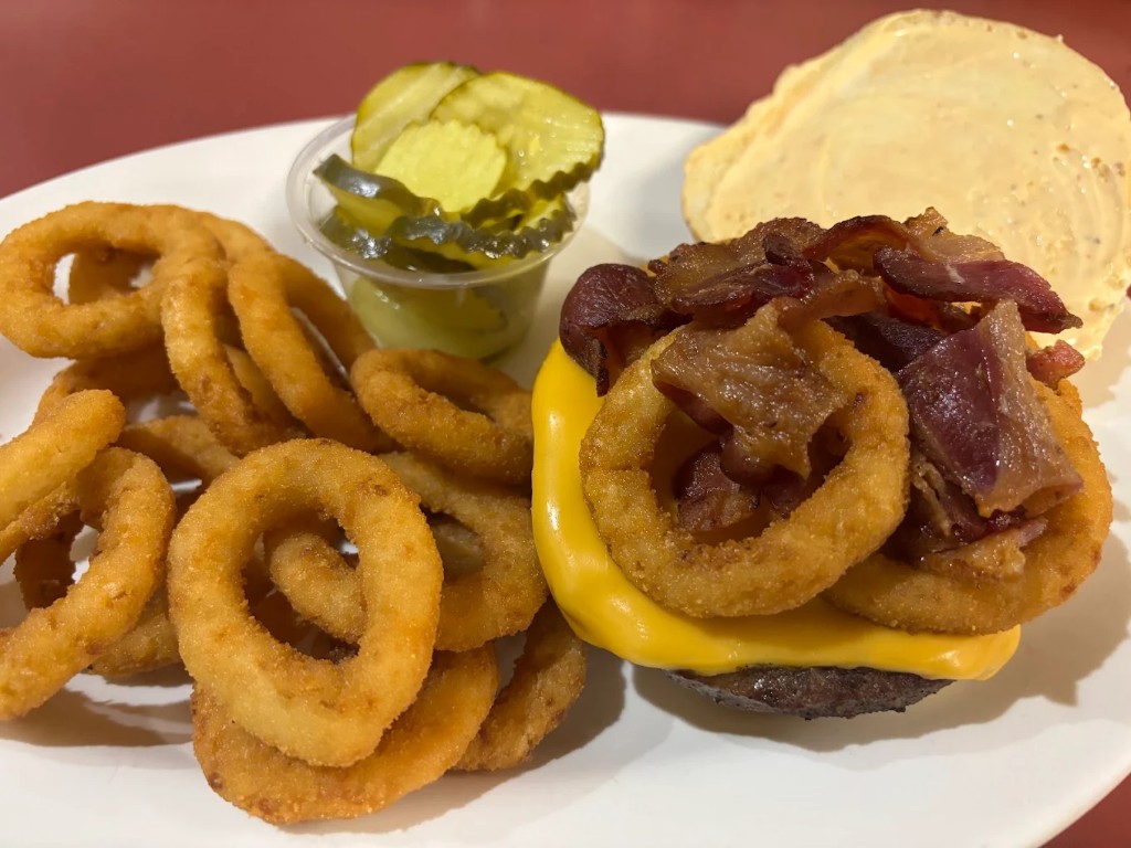 Burger with onion rings at Pecorino's Pizzeria